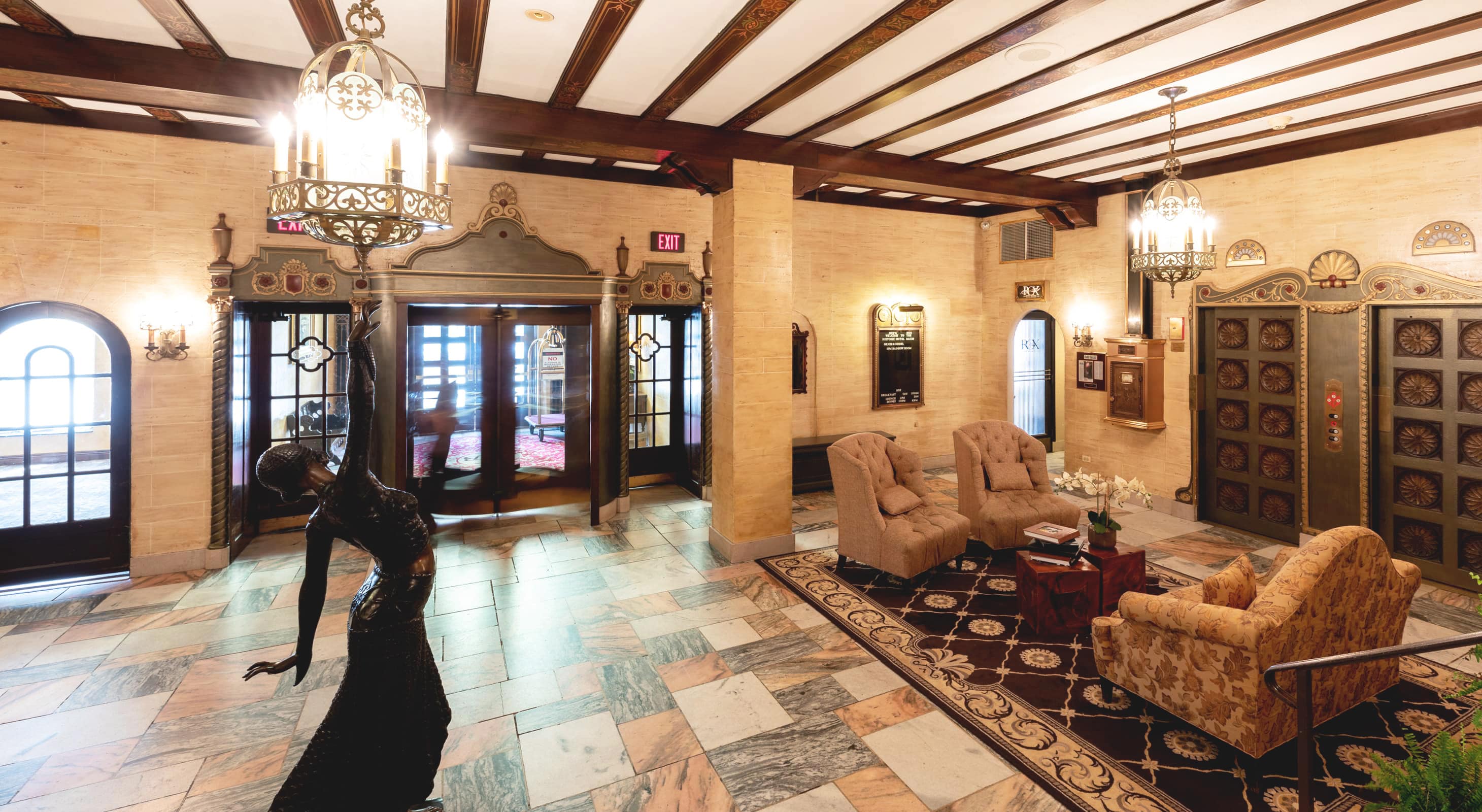 Hotel lobby with bronze statue and seating area
