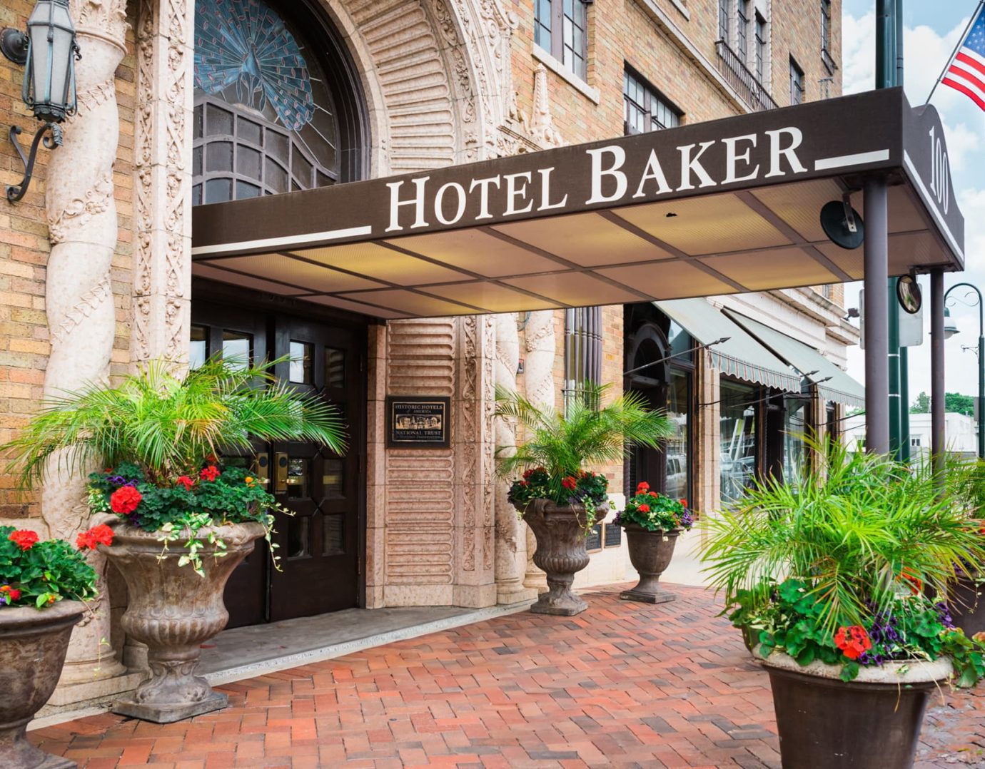 Front entrance of Hotel Baker with 1928 vintage stained glass peacock fanlight above the entry