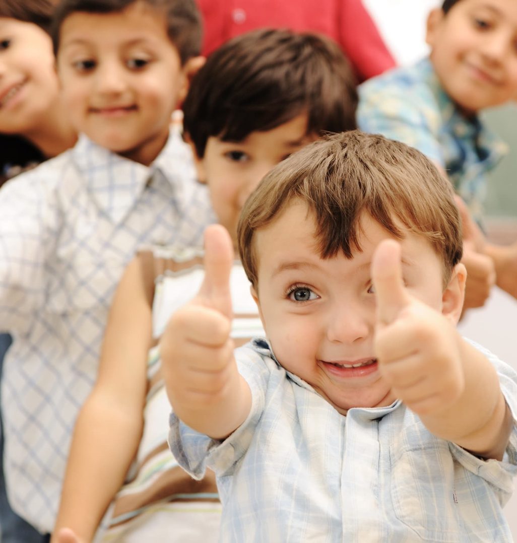 Smiling children giving thumbs up