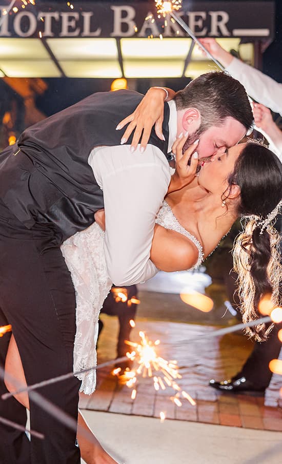 Bride and groom kiss outside a historic hotel in St. Charles, Illinois