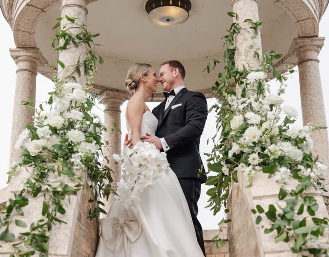 Bride and groom in the pergola on the Waterfront Patio