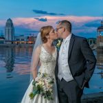 Bride and groom kiss at sunset on the banks of Fox River