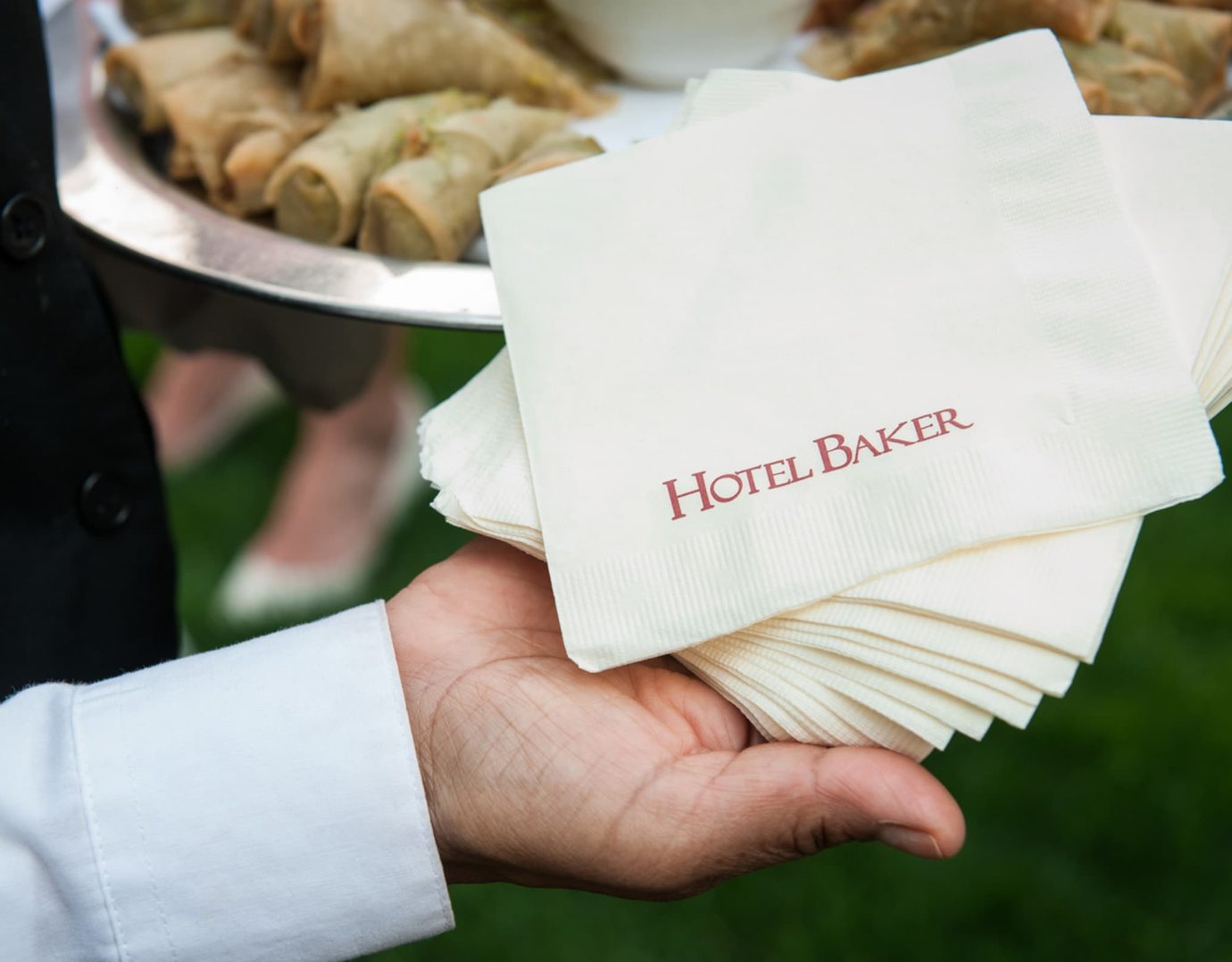 Server holding napkins for, passed hors-d'oeuvres, for guests of and event at Hotel Baker